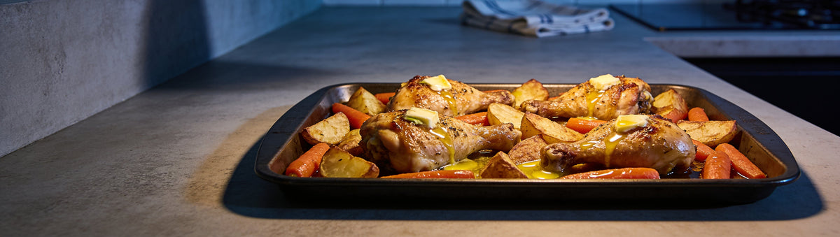 Butter-garlic roast chicken and veg seasoned with BBQ Mafia Double Butter Bang BBQ Rub in a tray