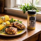 Barbecue Mafia Double Butter Bang BBQ Rub — buttery garlic grilled chicken thighs and charred corn beside the pack