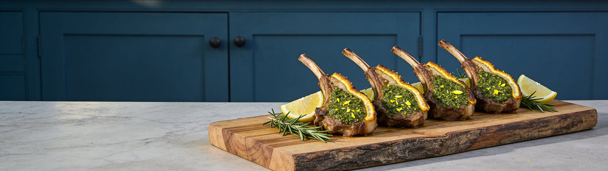 Herb and lemon crusted lamb cutlets seasoned with BBQ Mafia On the Lamb BBQ Rub on a timber board