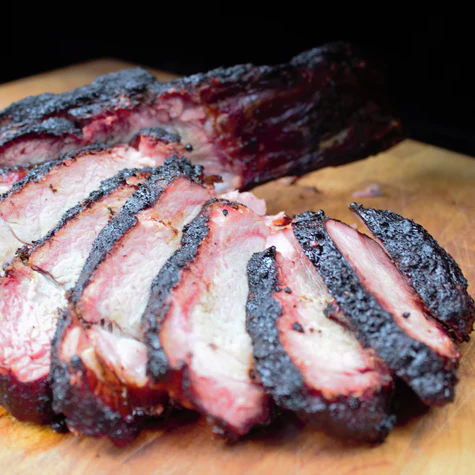 Alabama Jama-rubbed brisket sliced dark and smoky on a wood board lifestyle photo