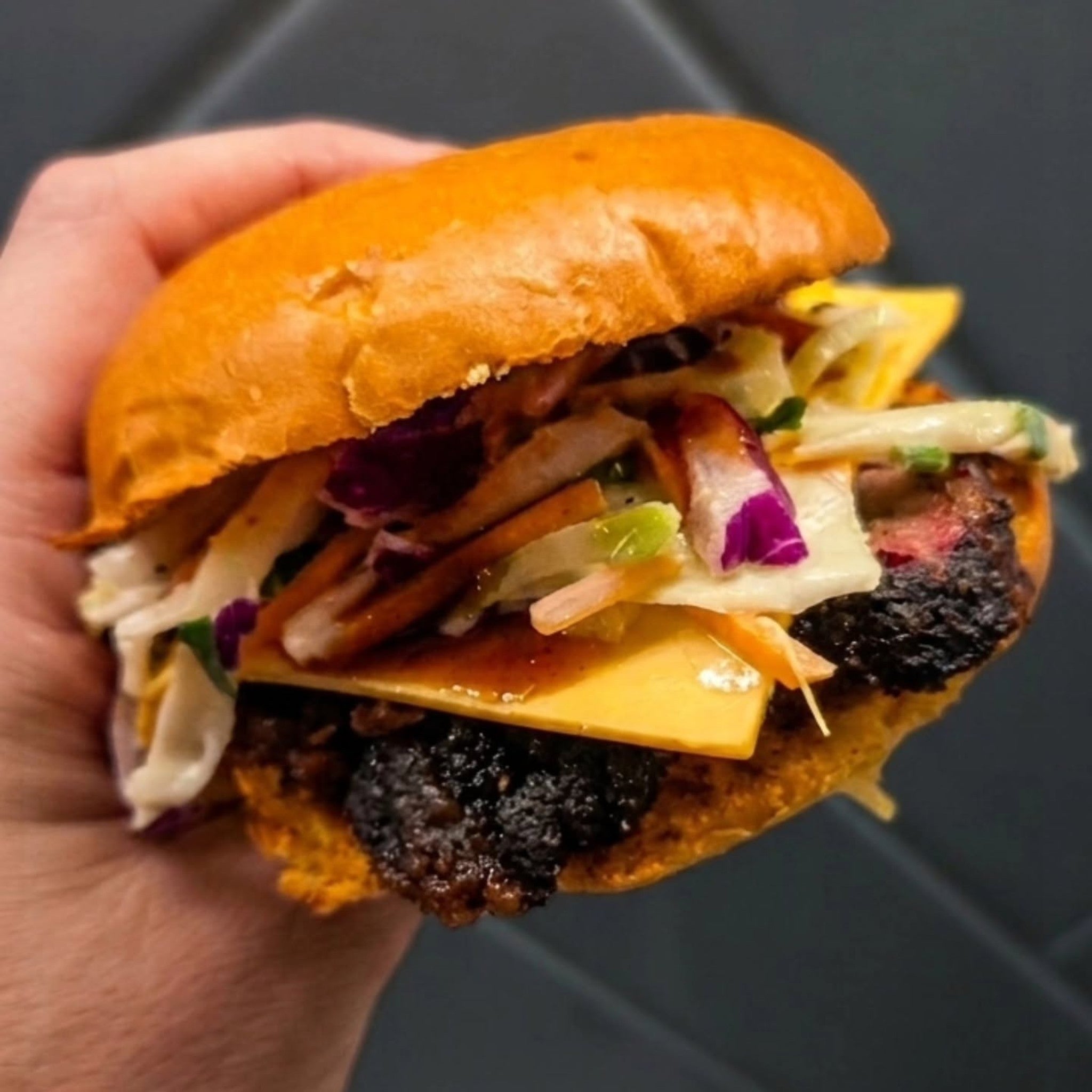 Butchers Axe Bullseye beef rub — stacked beef burger with bark-edged patty, cheese and slaw, cooked by Butchers Axe BBQ Melbourne