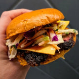 Stacked beef burger with a seasoned, seared patty, cooked by Butchers Axe BBQ Melbourne