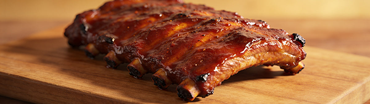Butchers Axe Ranger Red Rub — cinematic banner, rub composited into a lifestyle BBQ scene
