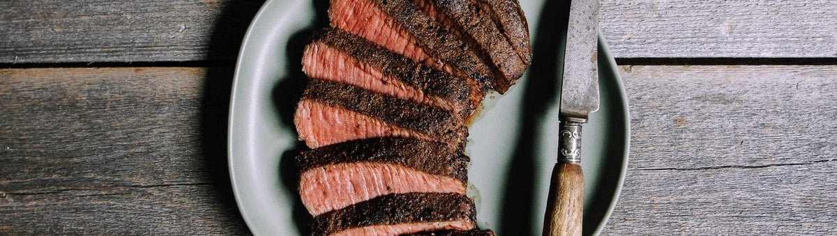 Hardcore Carnivore Camo game rub beside seared venison backstrap and lamb loin with a caramelised crust