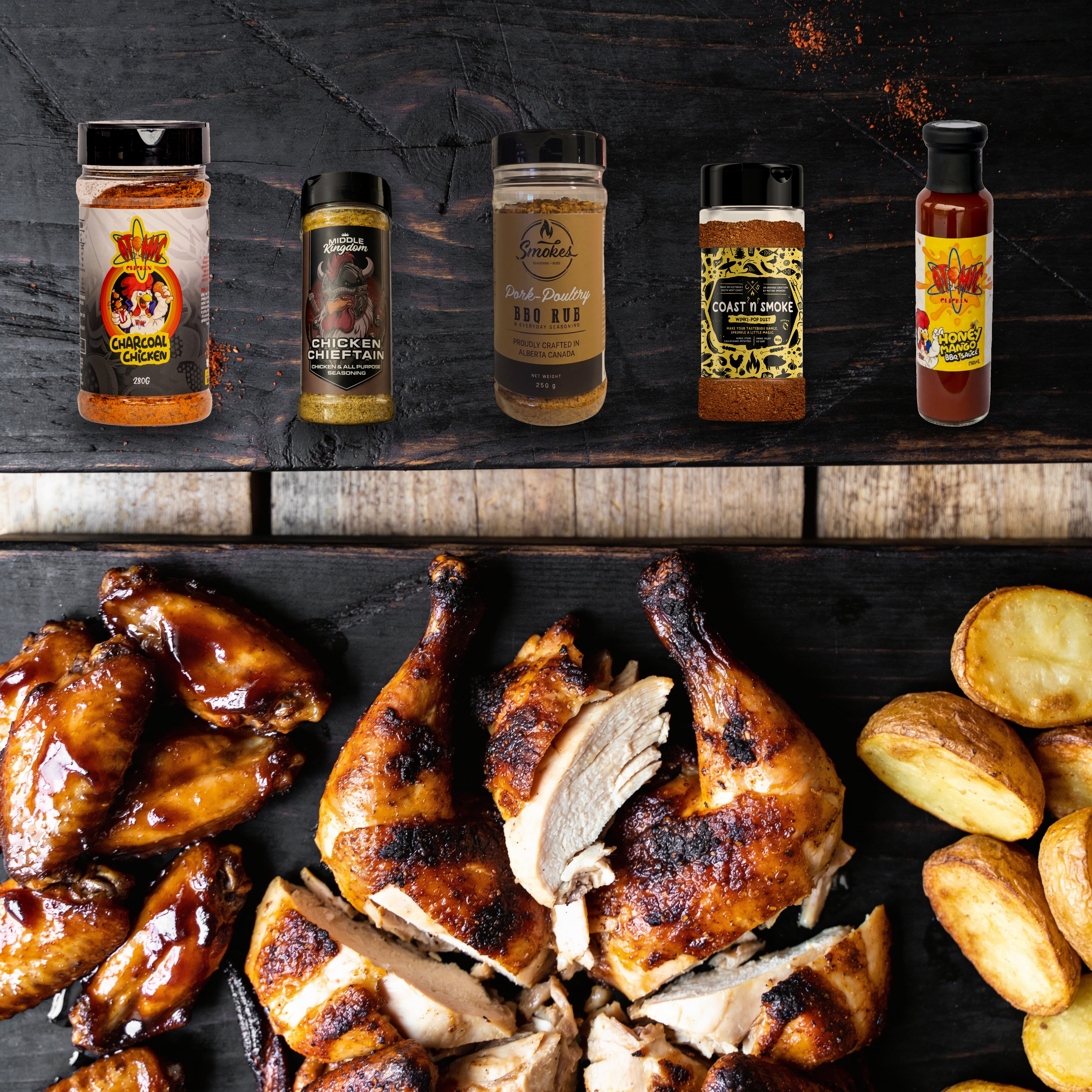 The Rub Hub Chicken Jockey box - all five products on a charred timber board with roast chicken, glazed wings and roast potatoes