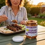 Chuck Hughes Mild Eggplant Relish spooned over lamb kofta skewers in the garden