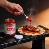 Chuck Hughes Mild Pepper Spread spooned onto a chargrilled chicken skewer and flatbread
