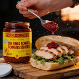 Chuck Hughes Sun-Dried Tomato Spread dropped onto a grilled chicken ciabatta