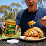 Chuck Hughes Spicy Mustard Coleslaw 375ml mustard slaw relish — spooning spicy mustard slaw onto a fried chicken roll