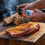 Chuds BBQ ChudRub 283g all-purpose Texas BBQ rub — seasoning a whole brisket on a timber block over post oak