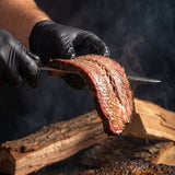 Chuds BBQ ChudRub 283g all-purpose Texas BBQ rub — a moist sliced brisket draping over the knife with a smoke ring and peppery bark