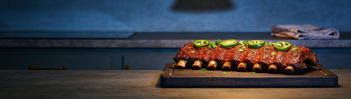 Jalapeño-topped spicy pork spare ribs on a kitchen island – Chuds BBQ SnakeBite