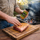 Coast n Smoke Bahia Barrels rub — cook rubbing the Brazilian spice into a raw picanha fat cap
