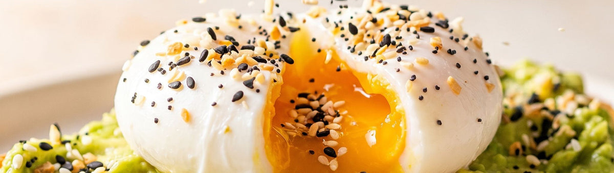 Coast n Smoke Bancoora Bagel Seasoning 180g banner — poached egg over smashed avo showered in seeded seasoning