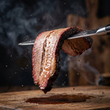 Coast n Smoke Bells Double Shot coffee rub — a moist smoked brisket slice draping over a knife, tender and juicy
