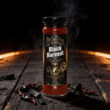 Cobra Chilli Black Harvest Chilli Sauce Super Extreme 150ml Hot Sauce — styled hero beauty shot in the Cobra Chilli dark gothic western aesthetic