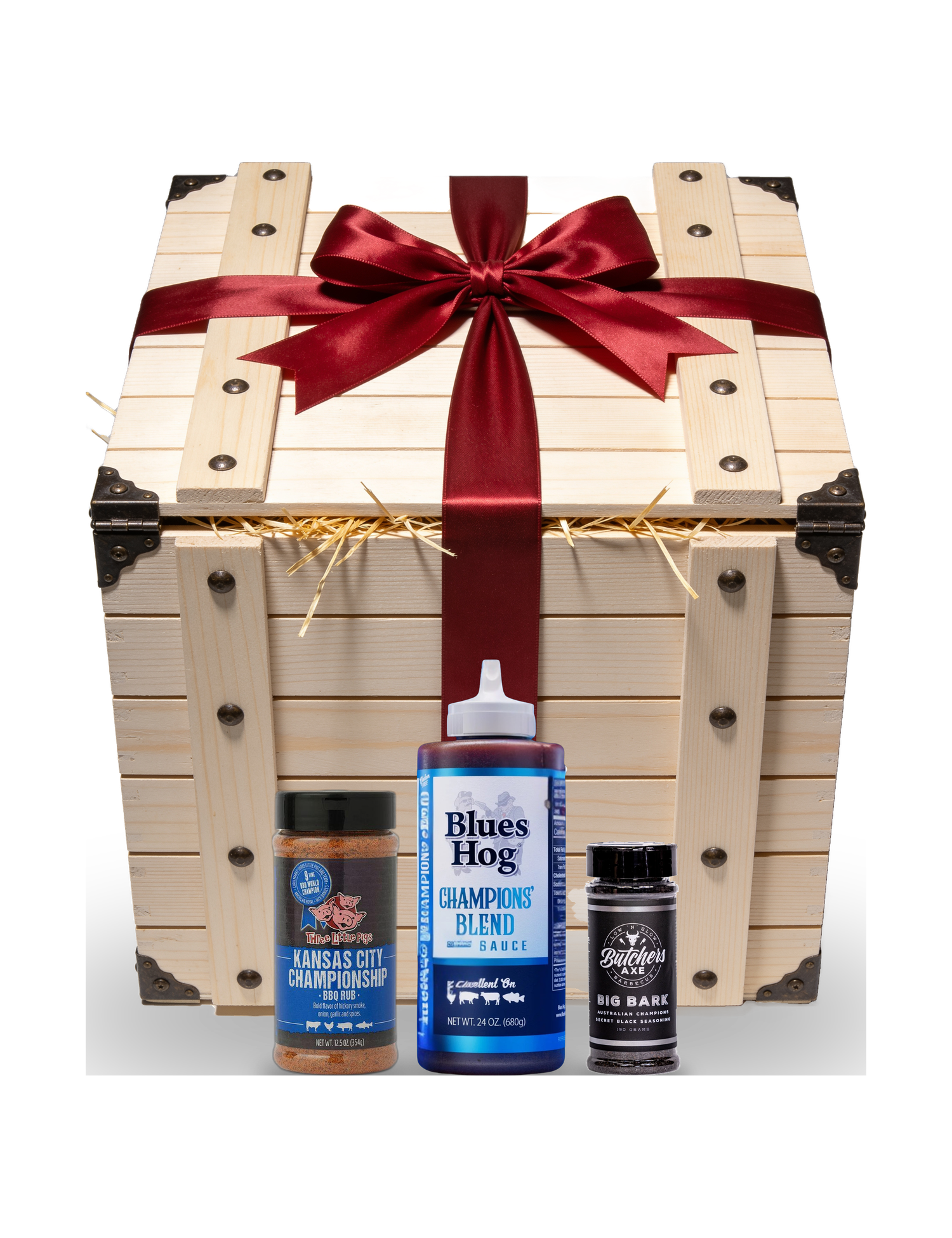 The Rub Hub The Smuggler's Gift Crate BBQ gift box — red-ribboned gift crate with example Three Little Pigs KC Championship, Blues Hog Champions' Blend and Butchers Axe Big Bark, on transparent background