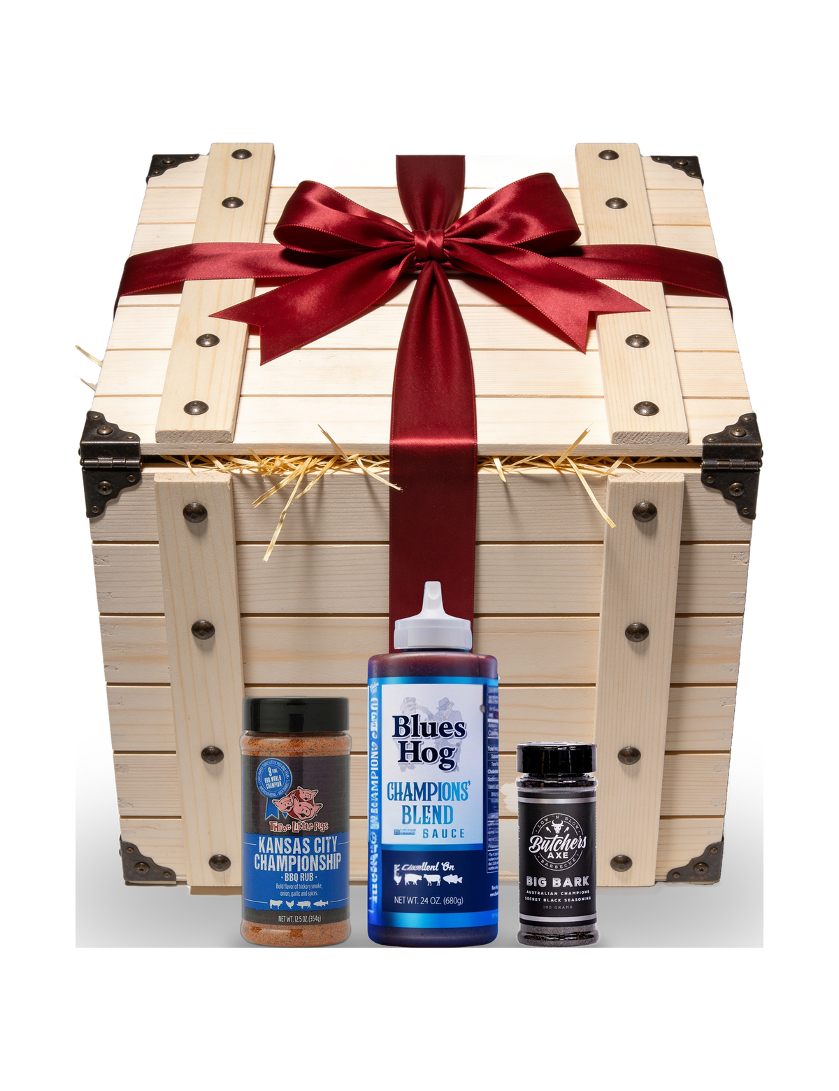 The Rub Hub The Smuggler's Gift Crate BBQ gift box — red-ribboned gift crate with example Three Little Pigs KC Championship, Blues Hog Champions' Blend and Butchers Axe Big Bark, on transparent background