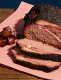The Kingpin lifestyle — sliced brisket with black bark and burnt ends on butcher paper