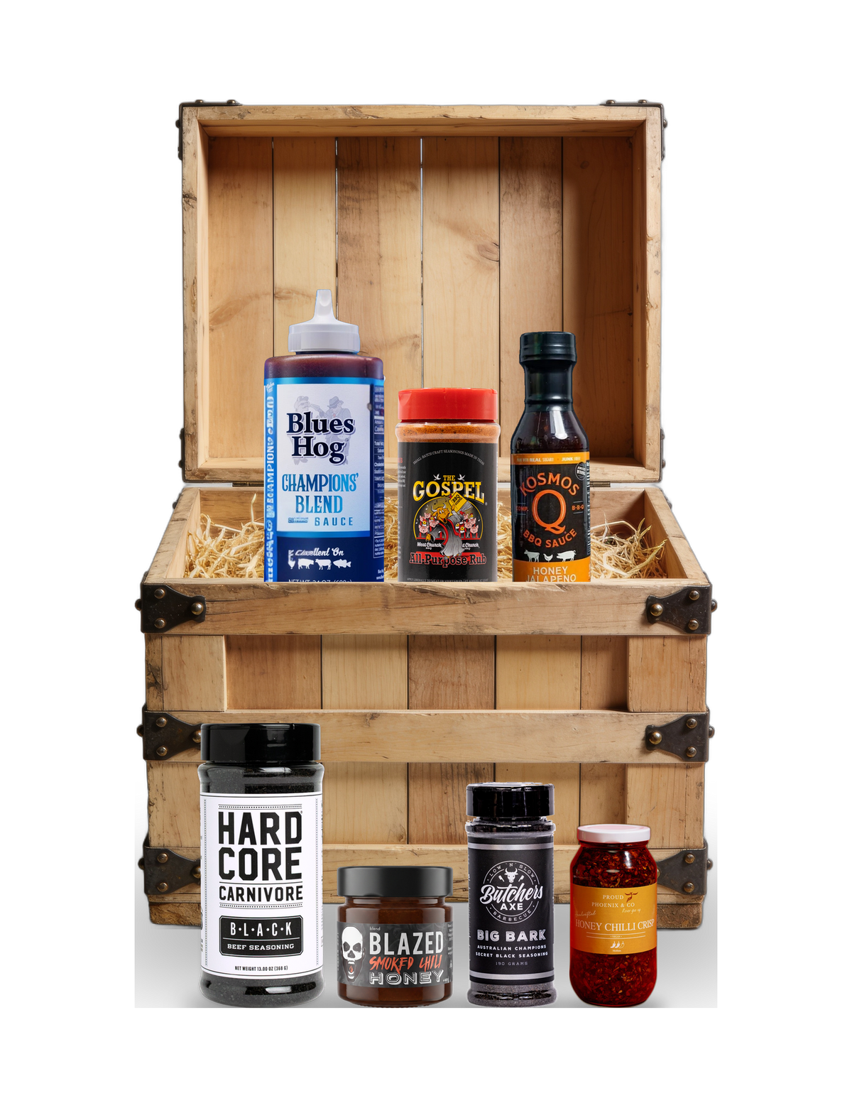 The Rub Hub The Quartermaster BBQ subscription box — example crate with Blues Hog Champions' Blend, Meat Church The Gospel, Kosmos Q, Hardcore Carnivore Black, BLEND Blazed honey, Big Bark and Proud Phoenix chilli crisp — contents change monthly, on transparent background