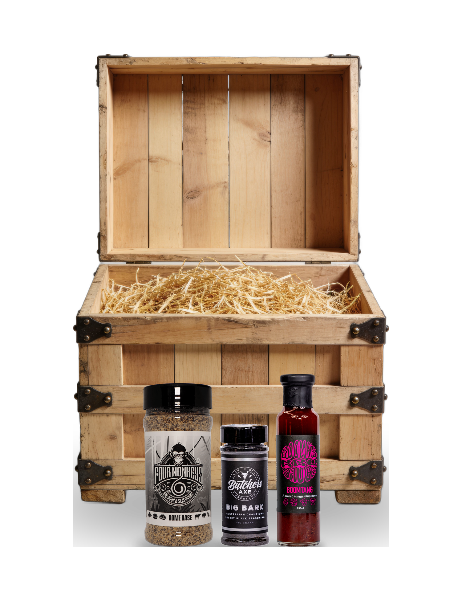 The Rub Hub The Stowaway BBQ subscription box — example crate with Four Monkeys Home Base, Butchers Axe Big Bark and Boomas Boomtang — contents change monthly, on transparent background