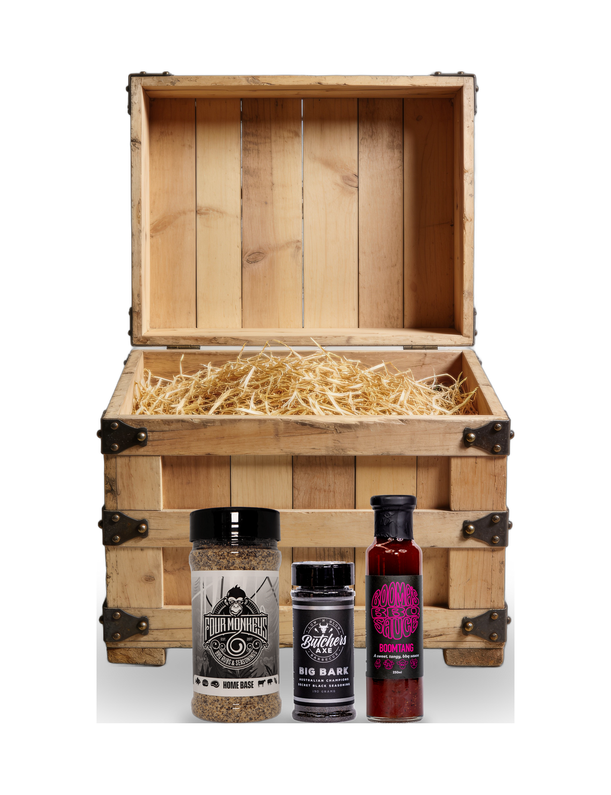 The Rub Hub The Stowaway BBQ subscription box — example crate with Four Monkeys Home Base, Butchers Axe Big Bark and Boomas Boomtang — contents change monthly, on transparent background