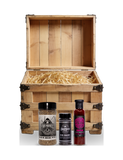 The Rub Hub The Stowaway BBQ subscription box — example crate with Four Monkeys Home Base, Butchers Axe Big Bark and Boomas Boomtang — contents change monthly, on transparent background