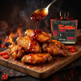 DC Cartel 1983 Extra Hot crispy chilli oil drizzled over glossy barbecue chicken wings on a board