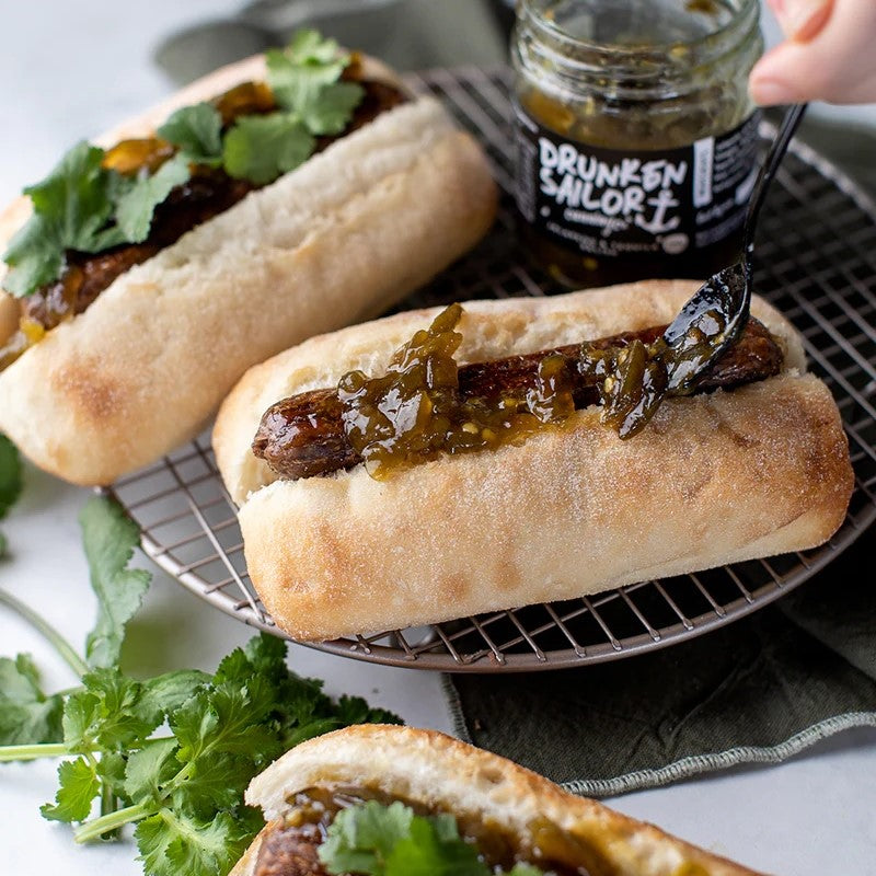 Drunken Sailor Jalapeno Tequila Relish spooned onto a hot dog lifestyle photo