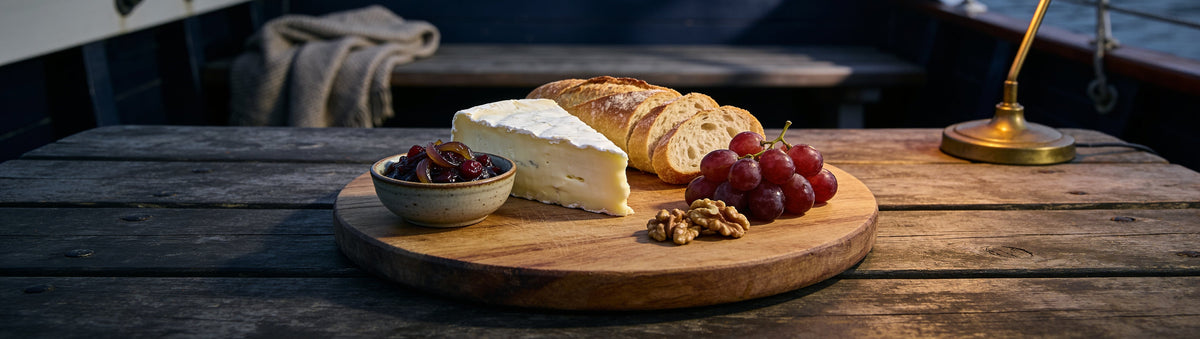 Brie, baguette and grapes on a cabin cheeseboard with Drunken Sailor Onion, Cranberry & Bourbon Relish