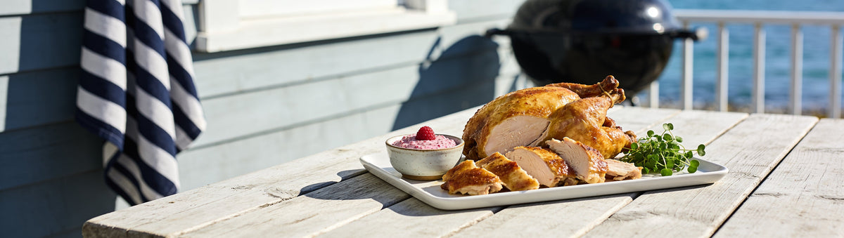 Carved roast chicken at a seaside cottage table with Drunken Sailor Raspberry & Wasabi Mustard