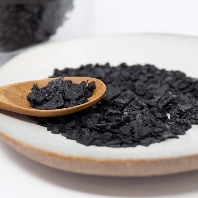 Falksalt Black sea salt flakes on a wooden spoon and ceramic plate lifestyle photo