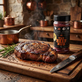 Four Saucemen The Beef Rub - seared ribeye steak with a dark peppery crust on a timber board