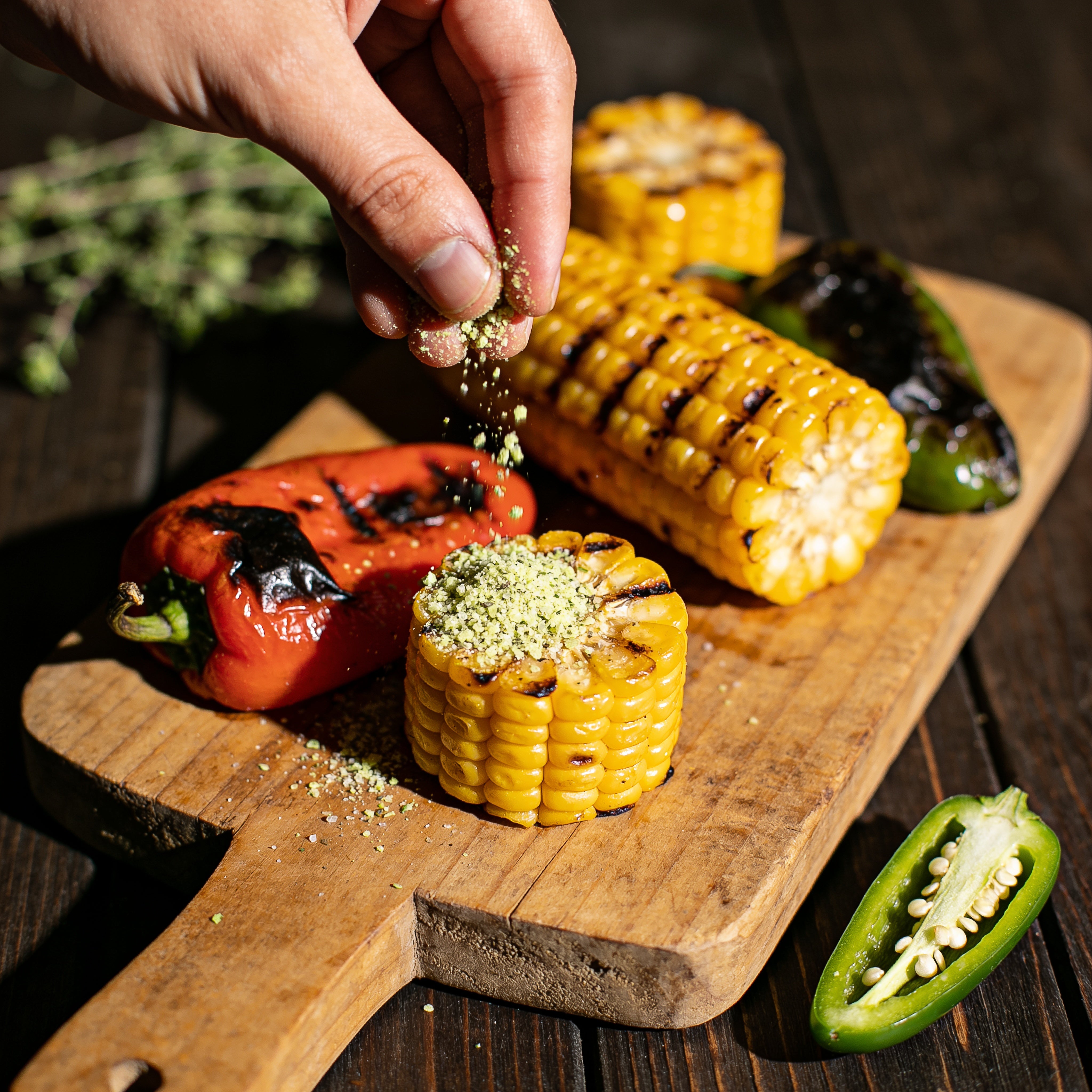 Smokes Seasoning Garlic Jalapeño Ranch sprinkled as a seasoning over grilled corn and peppers
