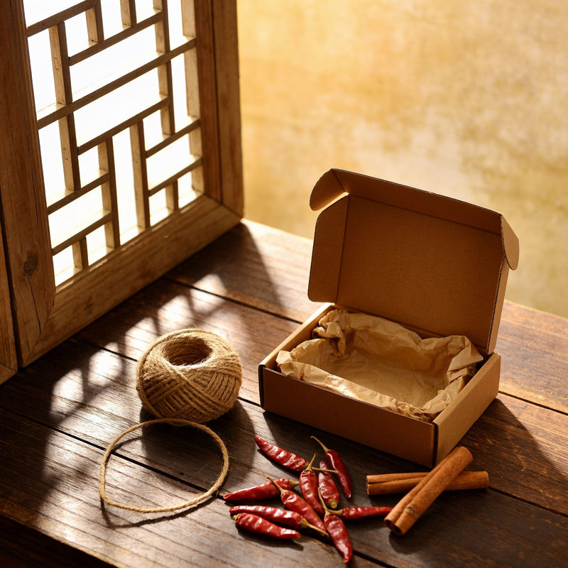 Gift Boxes category lifestyle photo — kraft box with jute twine and dried chillies lifestyle photo