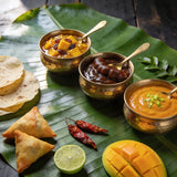 Goan Cuisine Chutney Trio bundle — mango, tamarind and mango lime chutneys in brass bowls on banana leaf