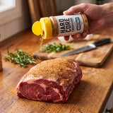 Hardcore Carnivore MeatyMite All-Purpose Rub — seasoning a raw beef steak from the shaker