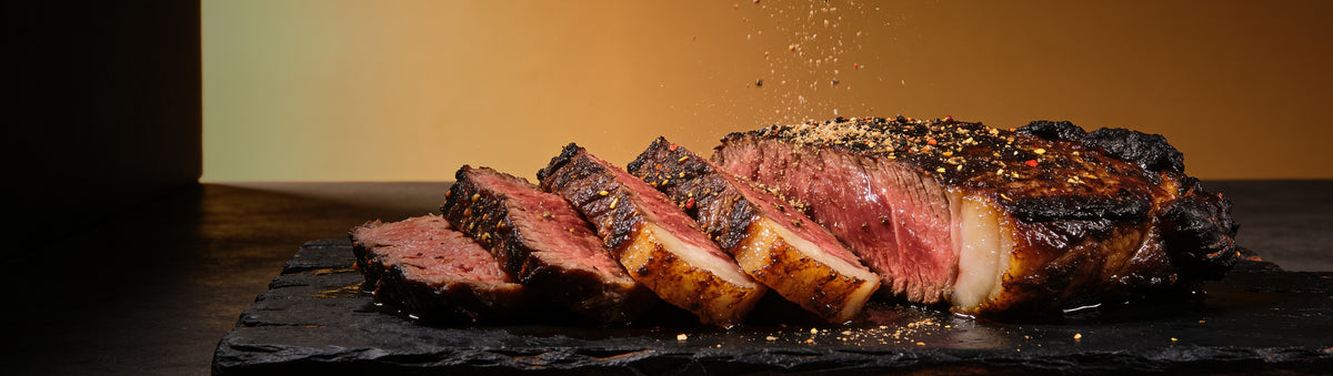 Heavenly Hell — Sliced picanha dusted with beef finishing dust mid-air