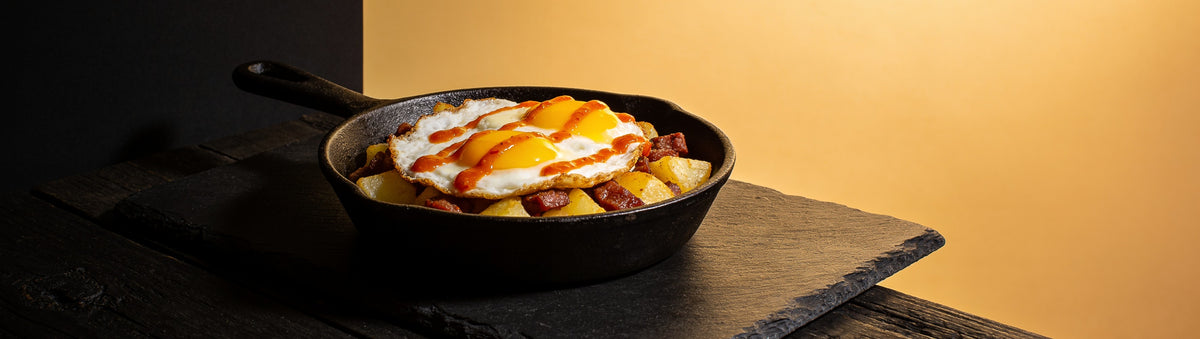 Heavenly Hell — Fried eggs and potatoes drizzled with cayenne habanero hot sauce