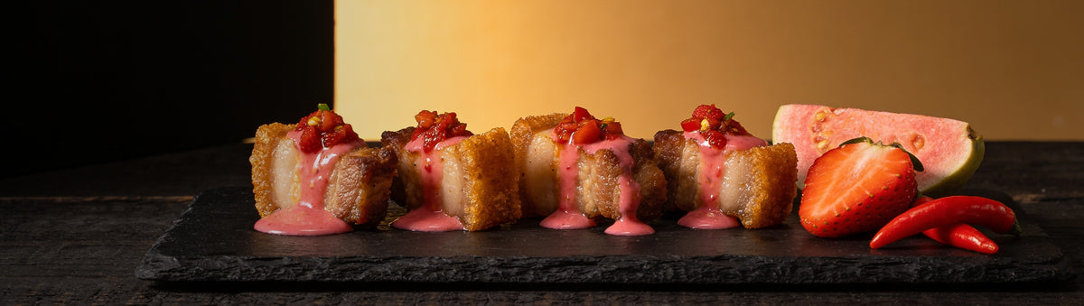 Heavenly Hell — Crackling pork belly bites with pink guava strawberry sauce