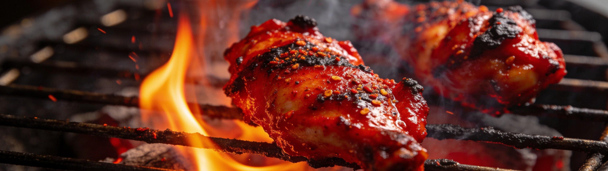 Jack Daniel's Fire BBQ Rub banner background — fiery red-glazed grilled chicken pieces with a peppery crust