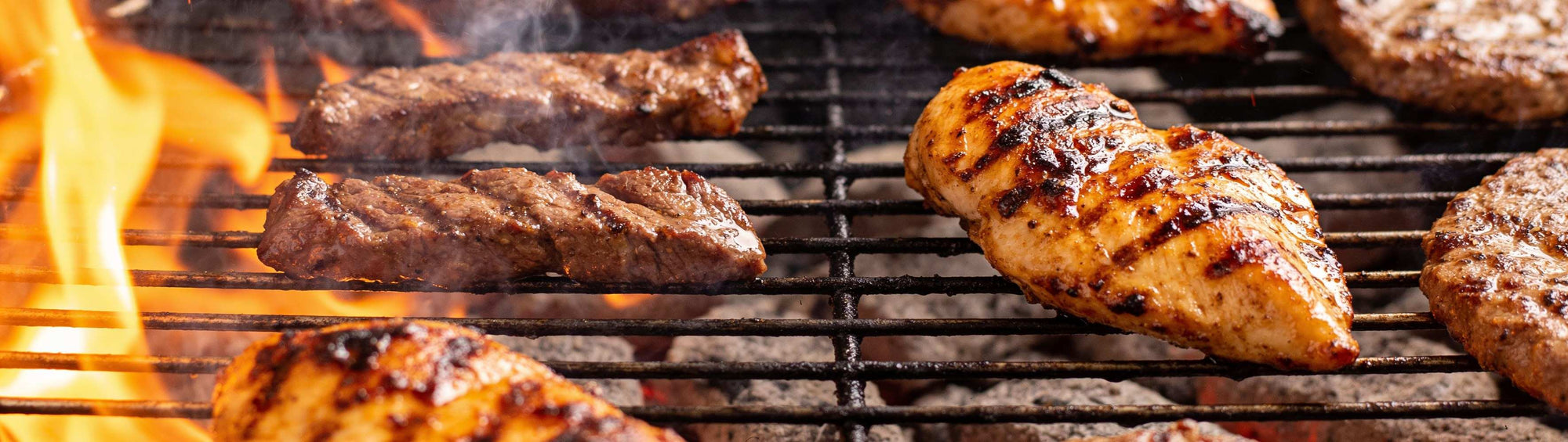 Jack Daniel's Original BBQ Rub banner background — grilled chicken, beef and pork glazed and charred over an open fire