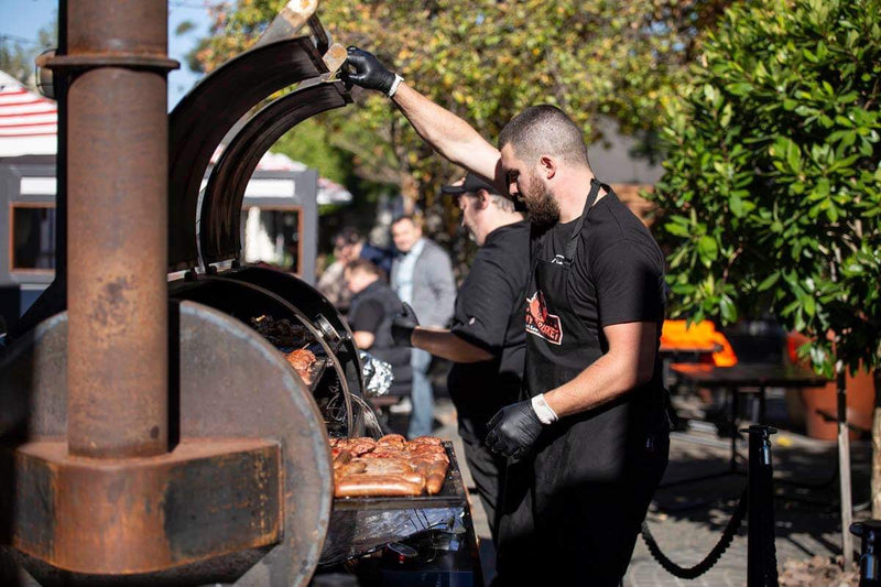 Jimmy Brisket crew working the offset smoker at a catering event in Melbourne lifestyle photo