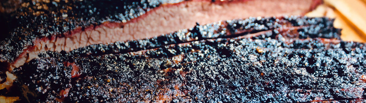 Jimmy Brisket Special Ops beef rub with a real Jimmy Brisket smoked brisket — crunchy peppery bark and pink smoke ring