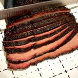 Jimmy Brisket Special Ops 280g beef rub — Jimmy Brisket slicing a smoked brisket with a peppery bark and smoke ring