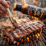 Holy Grail Hog glaze brushed onto pork ribs on the grill
