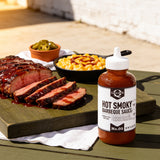 Lillie's Q Hot Smoky Barbeque Sauce 380ml spicy BBQ sauce — sliced glazed tri-tip with a skillet of mac and cheese