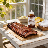 Lillie's Q Smoky Barbeque Sauce 380ml BBQ sauce — sticky glazed pork back ribs on butcher paper on a sunny porch table