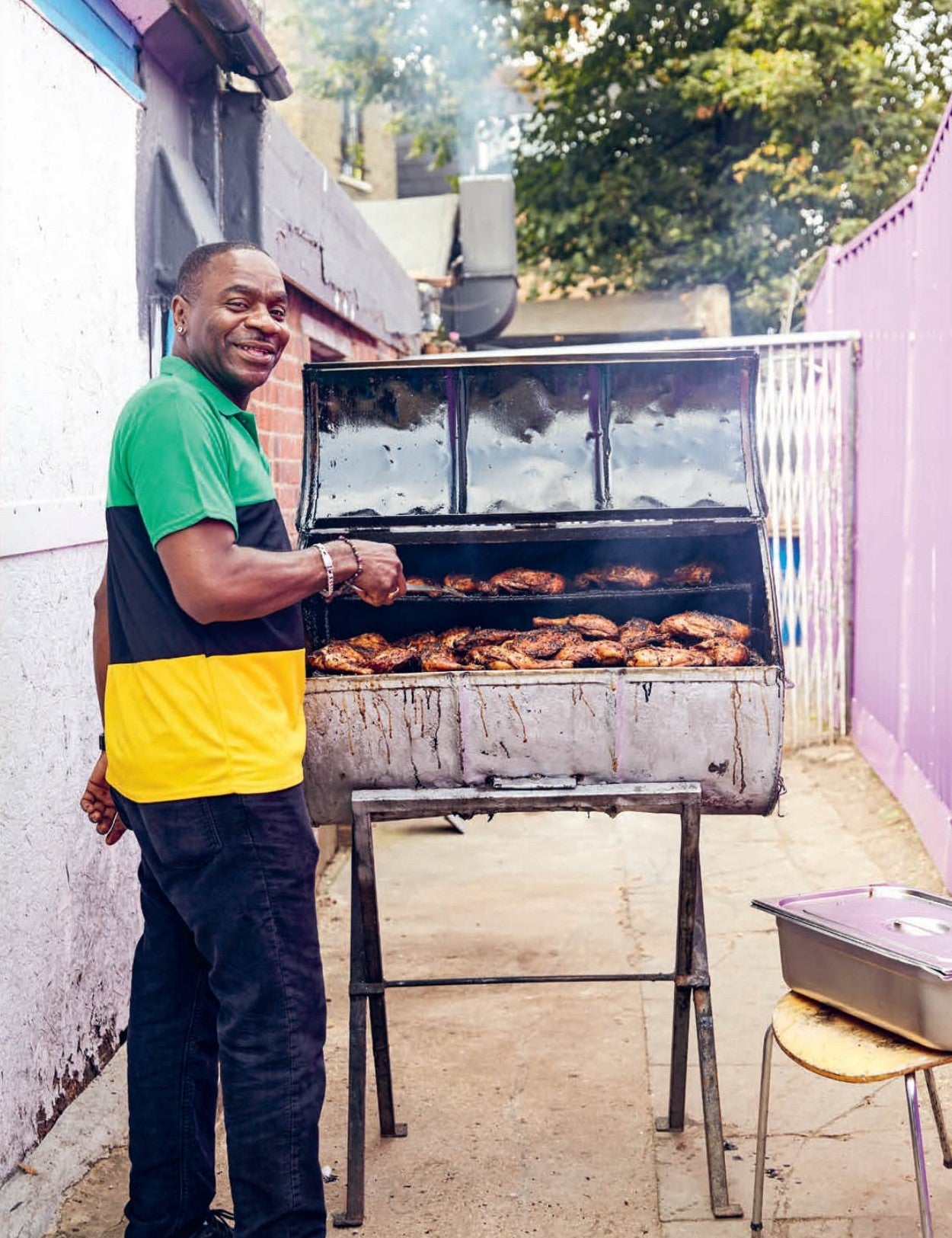 Live Fire by Helen Graves hardback cookbook — Jamaican jerk chicken feature with a cook at the grill