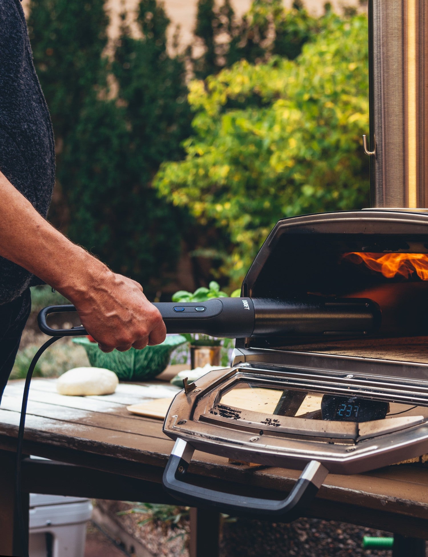 Looftlighter Pro lighting a backyard pizza oven